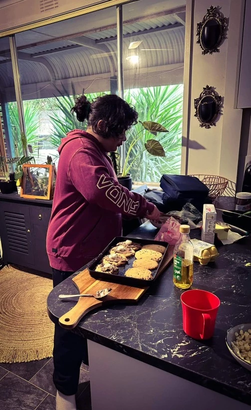 Disabled boy making cookies in kitchen at home